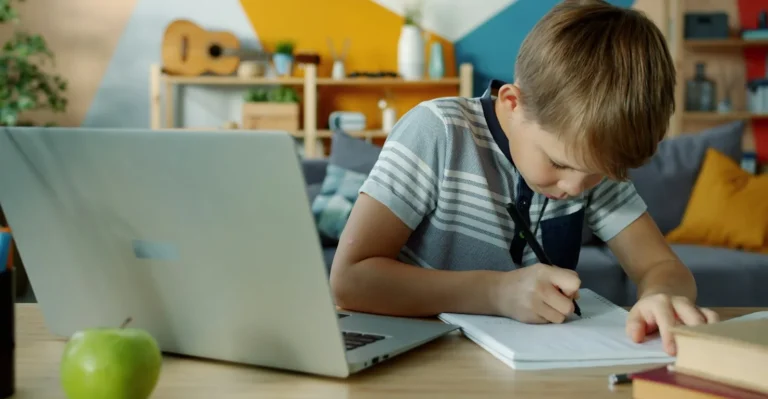 Élève qui écrit dans un cahier à côté d'un ordinateur portable, illustration d'exercices Python débutant