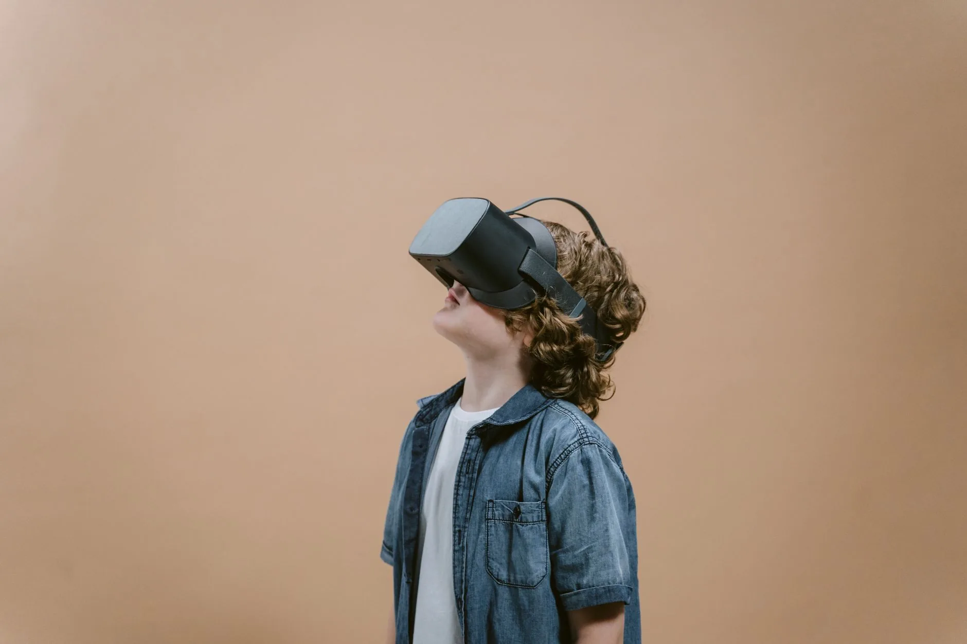 A young boy exploring virtual reality with a VR headset in a studio setting. — rag (retrieval-augmented generation)