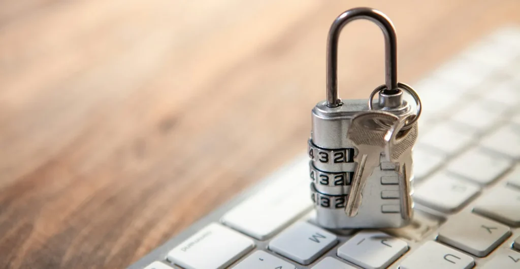 Cadenas à code et clés posés sur un clavier d'ordinateur, illustration d'un gestionnaire de mots de passe