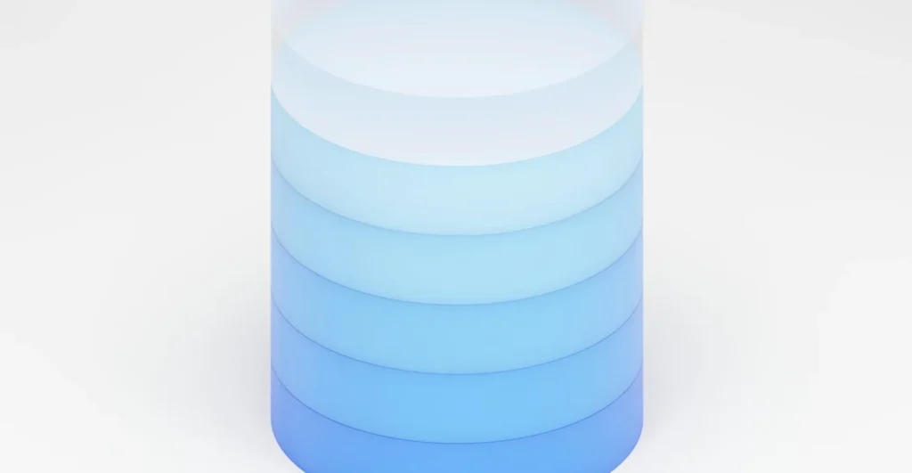 Rendu 3D d'un cylindre empilé en dégradé de bleu, symbole d'une base de données, illustration d'un cours SQL débutant
